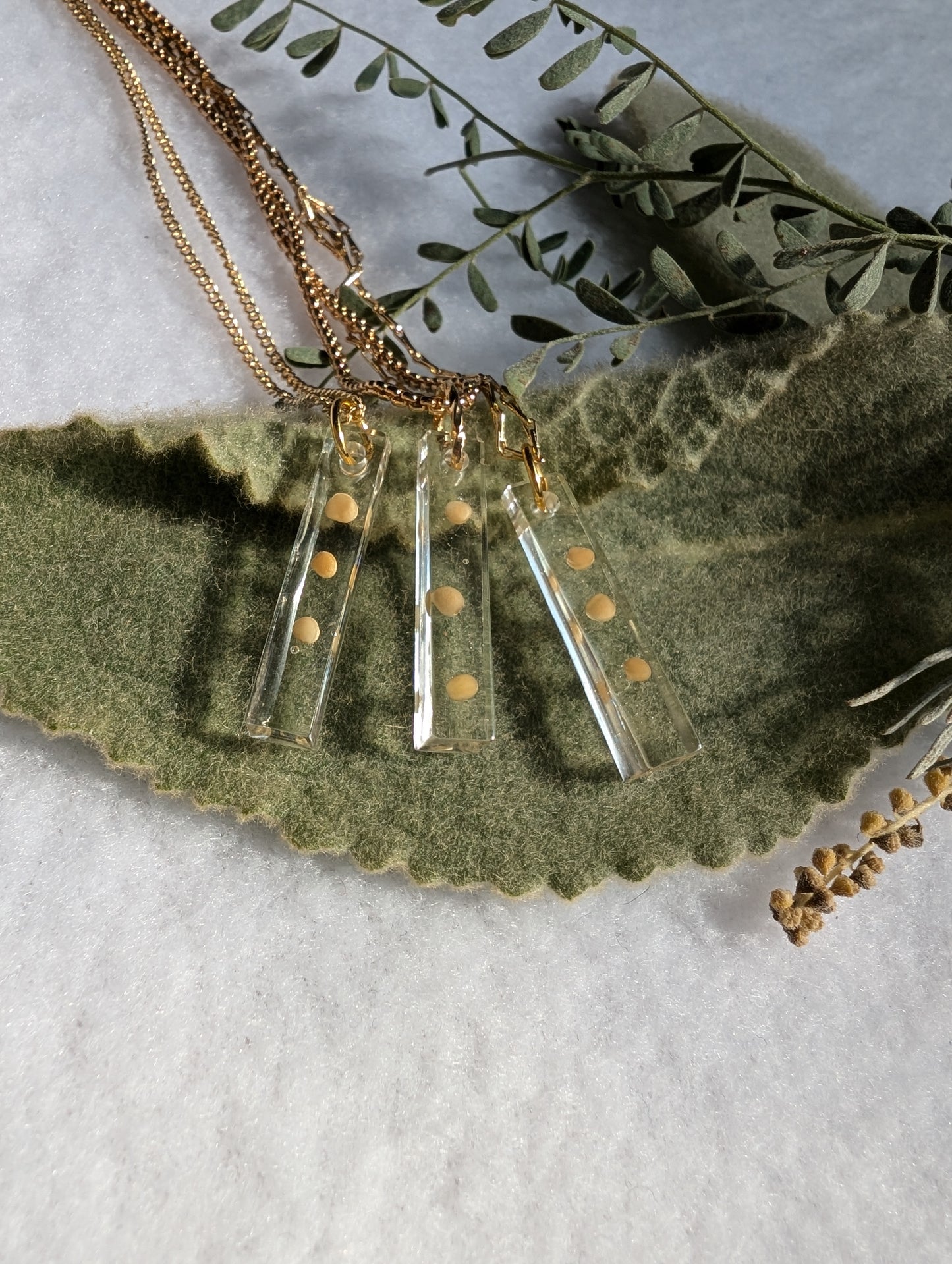 Trinity (3) mustard seed necklace cast with a rectangular gem shape and dainty gold chain