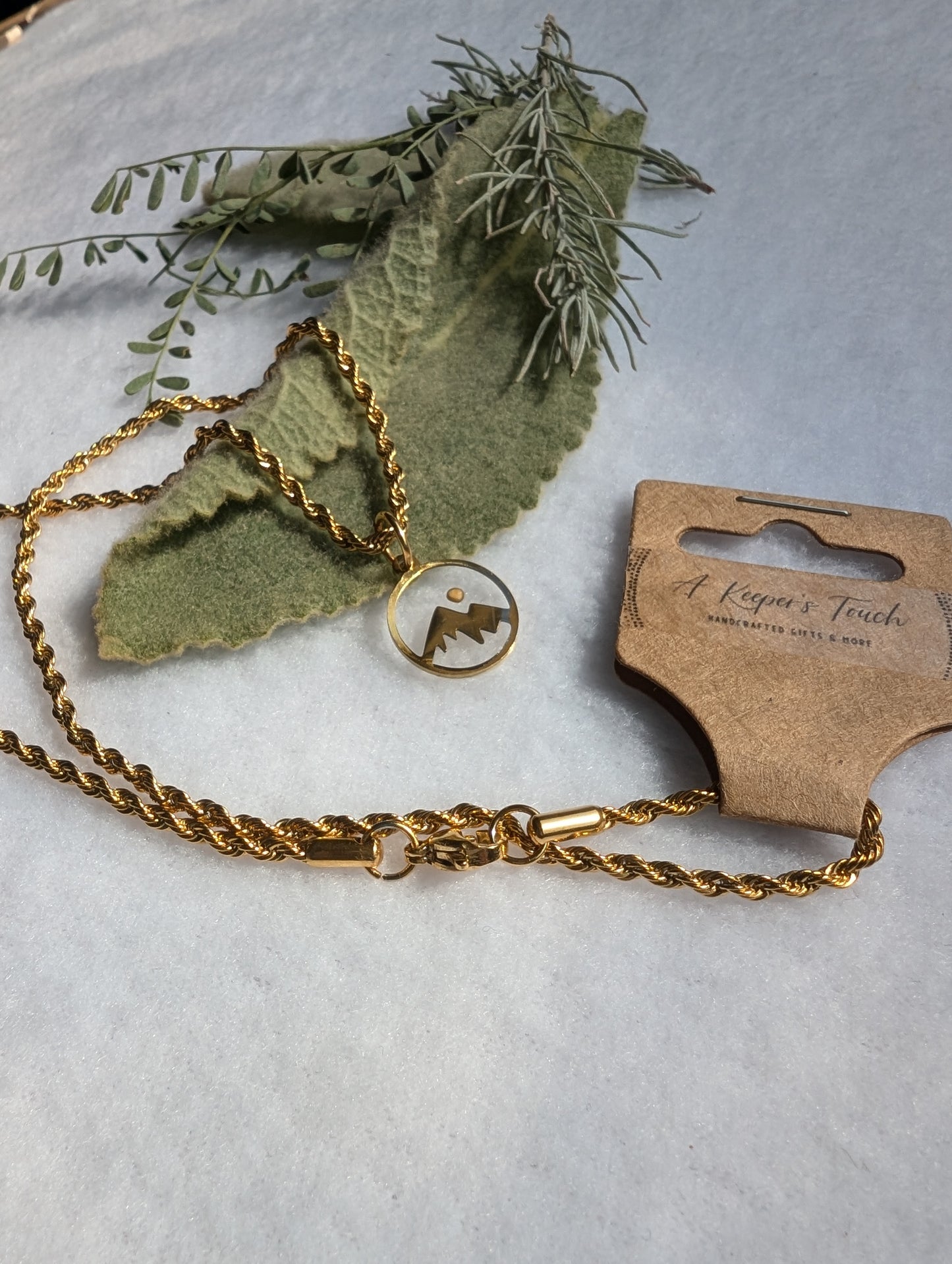 Gold mountain mustard seed pendant with gold plated rope chain