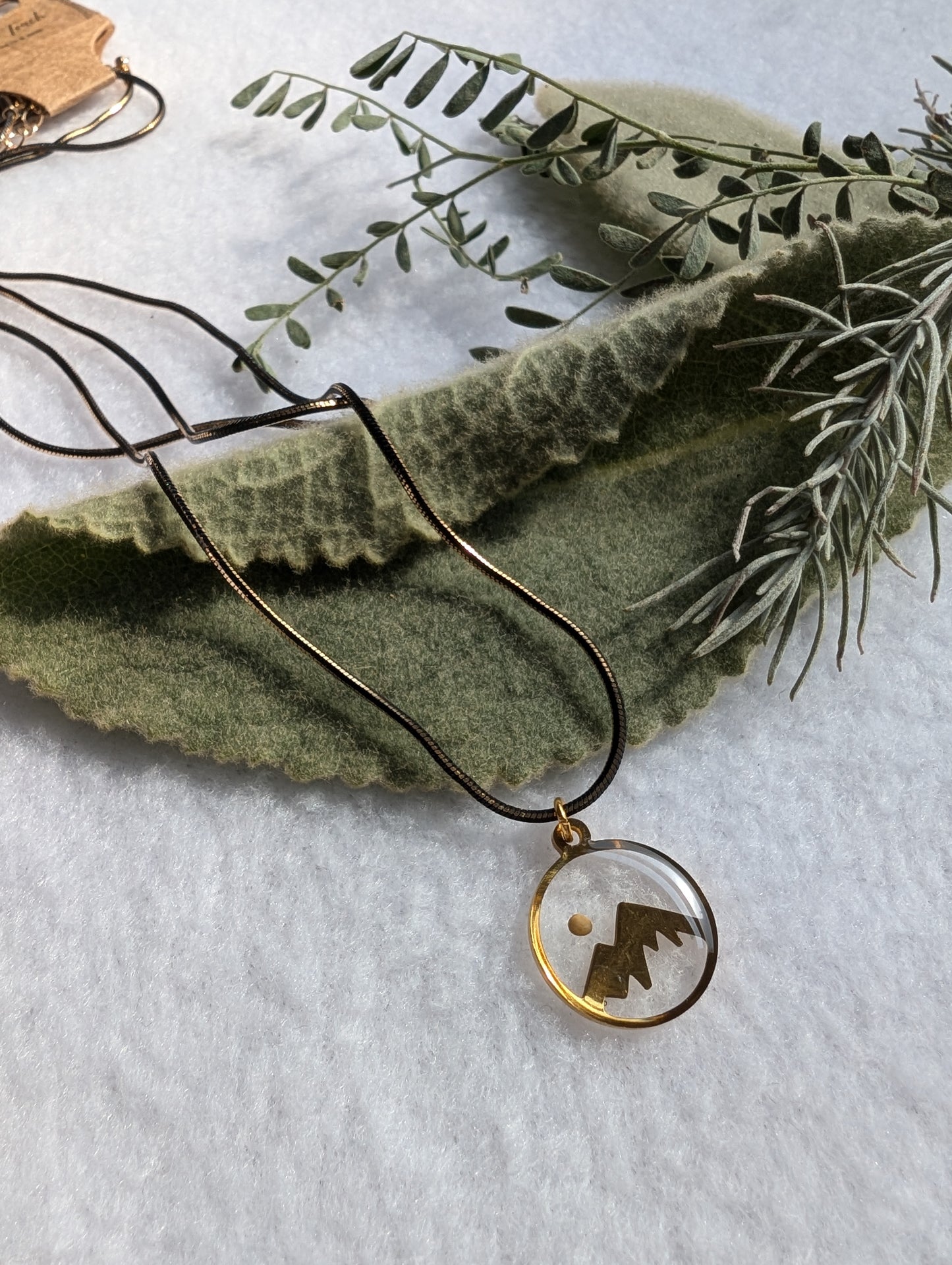 Gold mountain mustard seed necklace with long black and gold chain