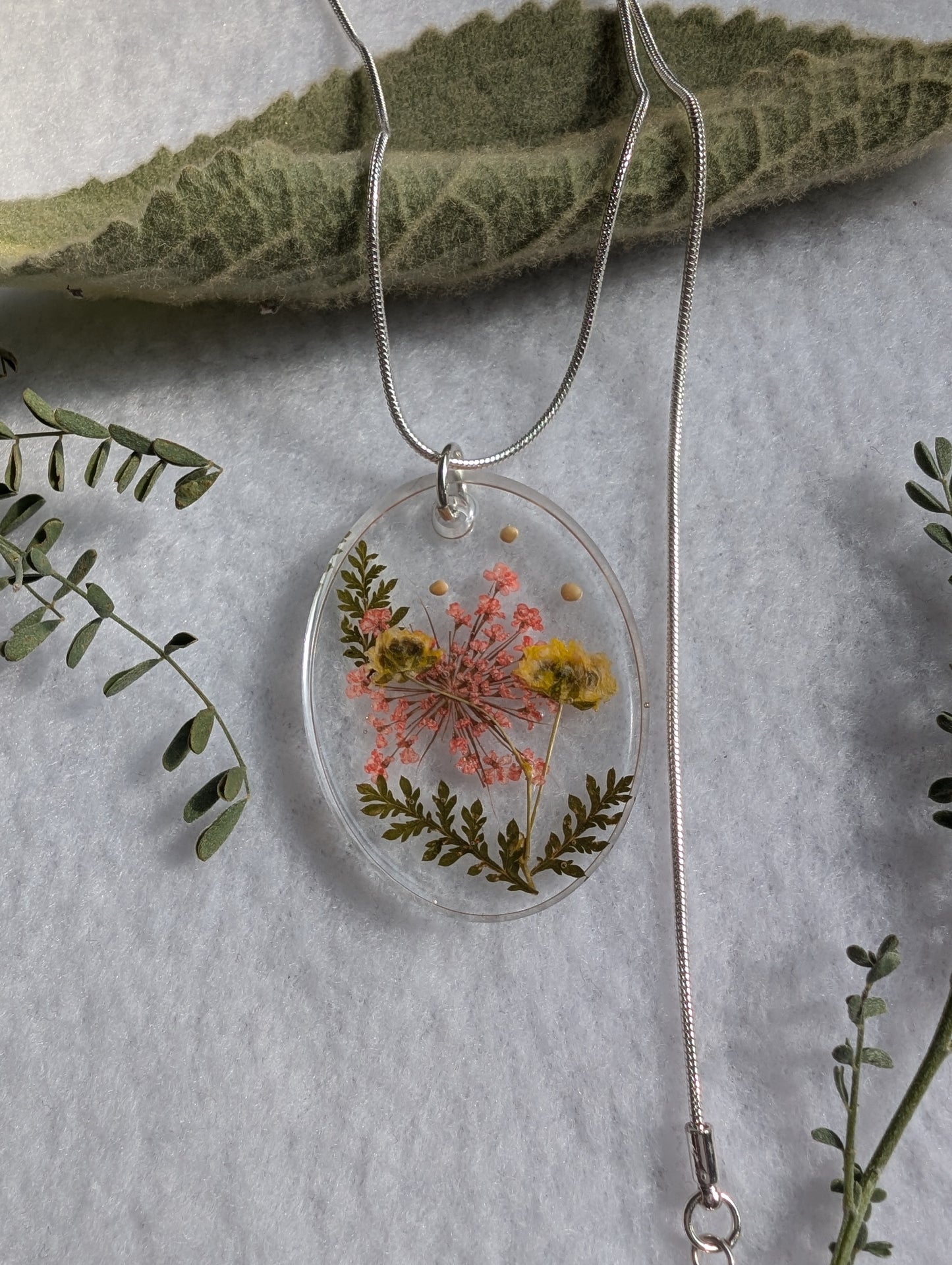 Floral and mustard seed embellished large oval pendant with adjustable silver chain