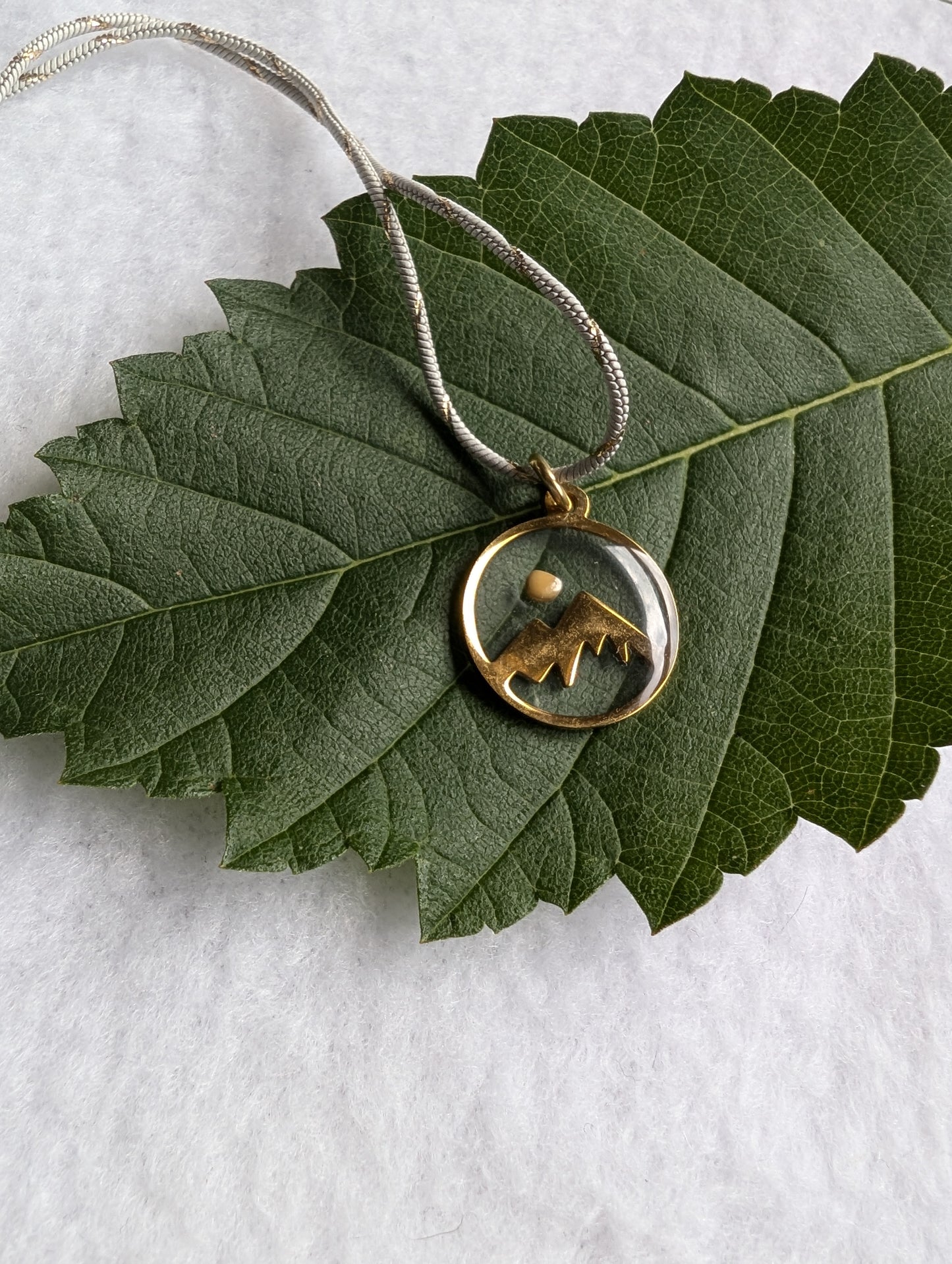 Gold mountain mustard seed pendant with white and gold chain