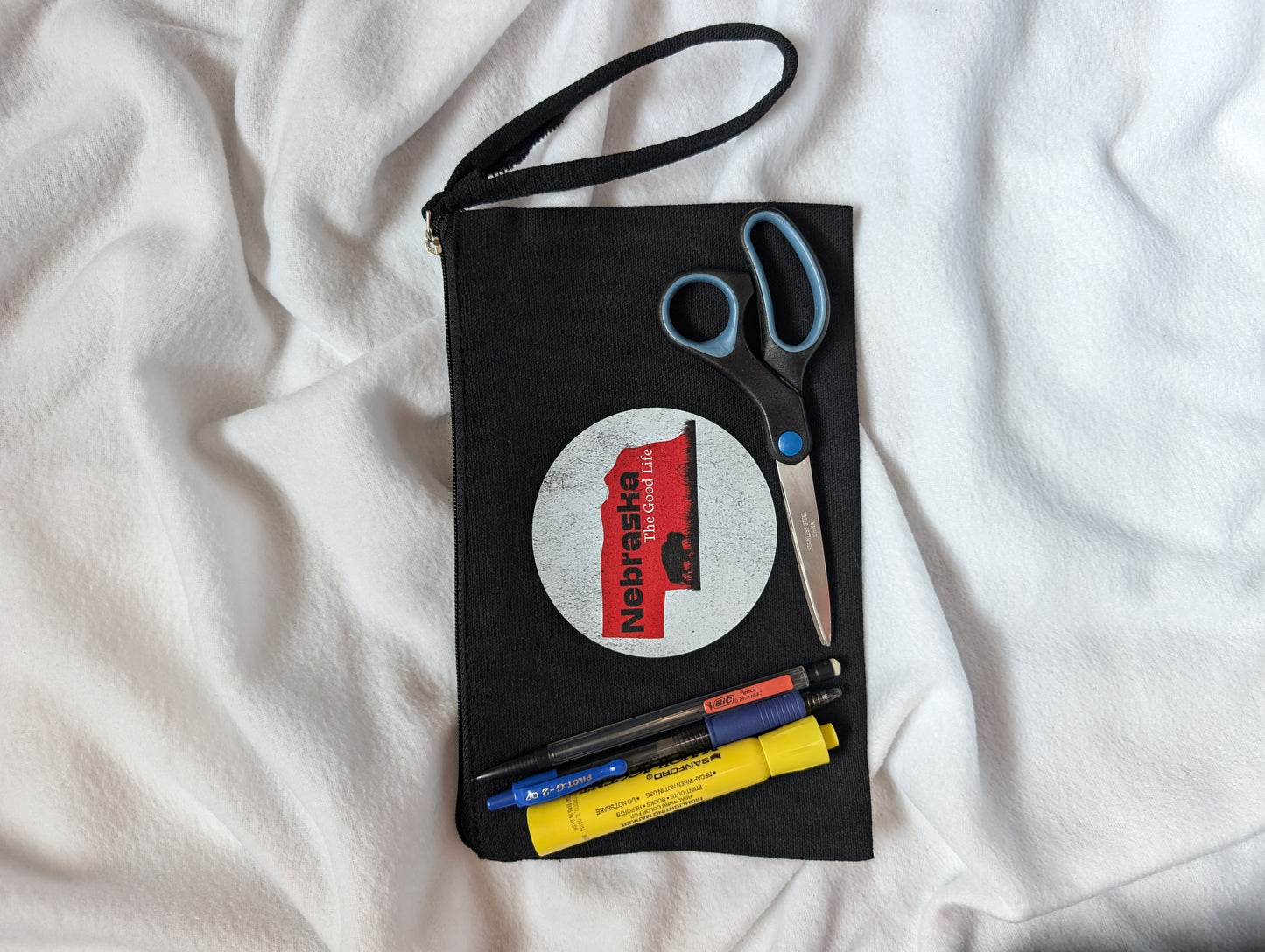 Black wristlet zipper pouch with Nebraska Bison design