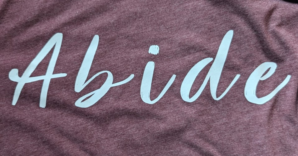 White Abide design on a heather maroon Medium T Shirt