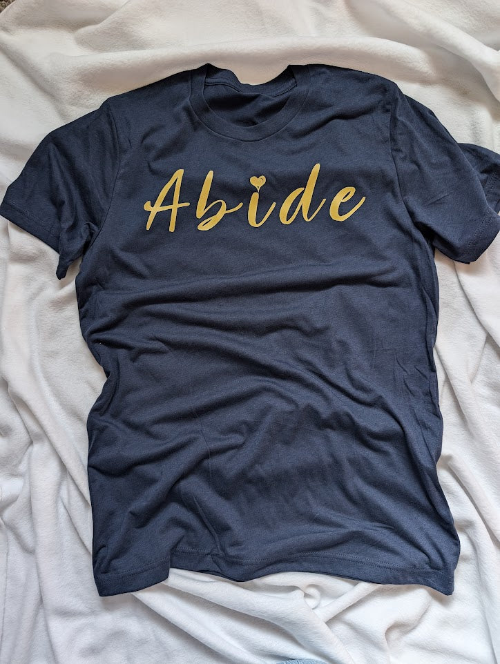 Gold Abide design on a blue Medium T Shirt