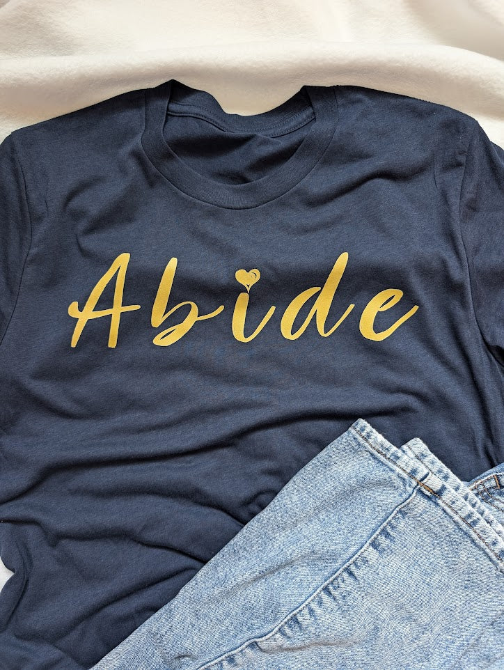 Gold Abide design on a blue Medium T Shirt