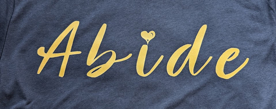 Gold Abide design on a blue Medium T Shirt
