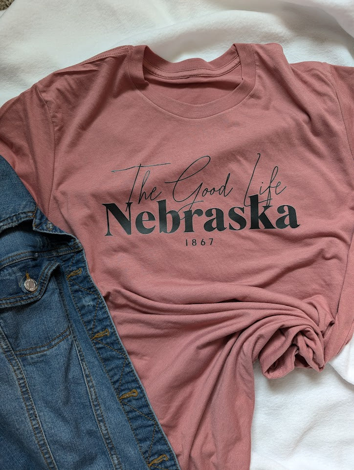 The Good Life Nebraska design on a mauve colored Large T Shirt