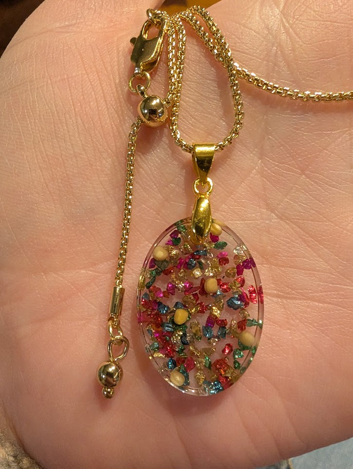 multicolored oval mustard seed necklace with gold colored adjustable chain