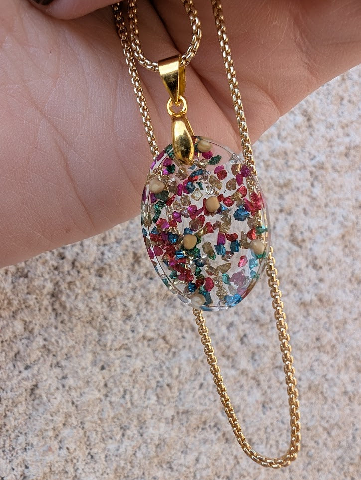 multicolored oval mustard seed necklace with gold colored adjustable chain