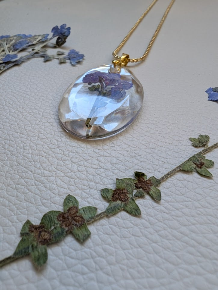 Clear gem; cluster forget-me-nots, long gold chain