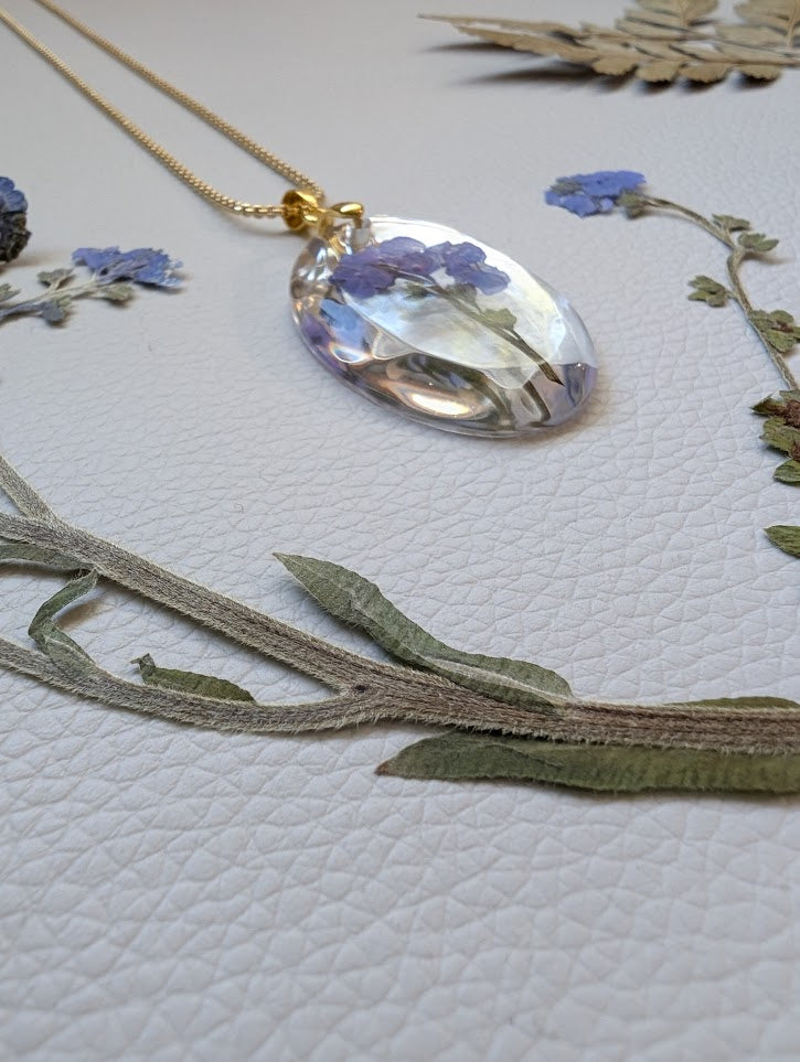 Clear gem; cluster forget-me-nots, long gold chain