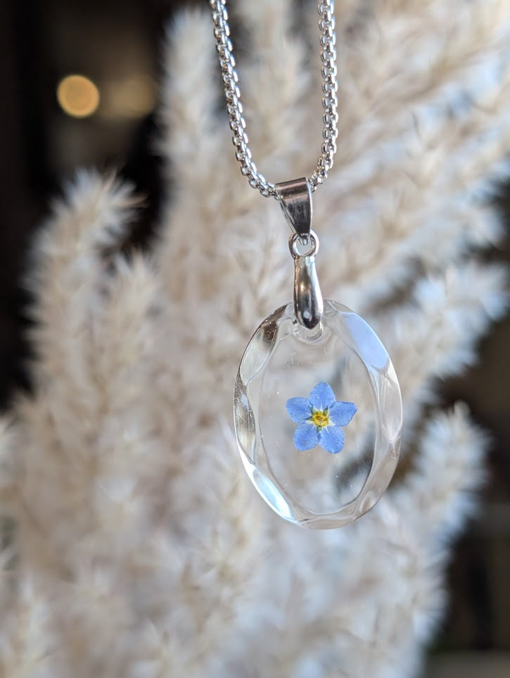 Clear gem; single forget-me-not, long silver chain
