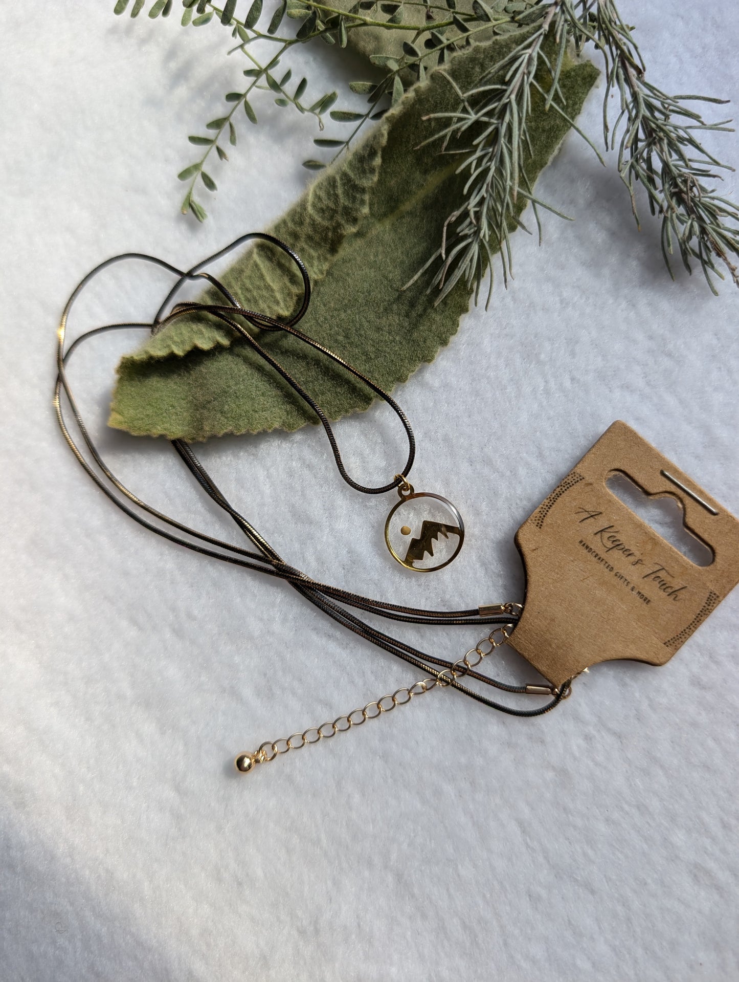 Gold mountain mustard seed necklace with long black and gold chain