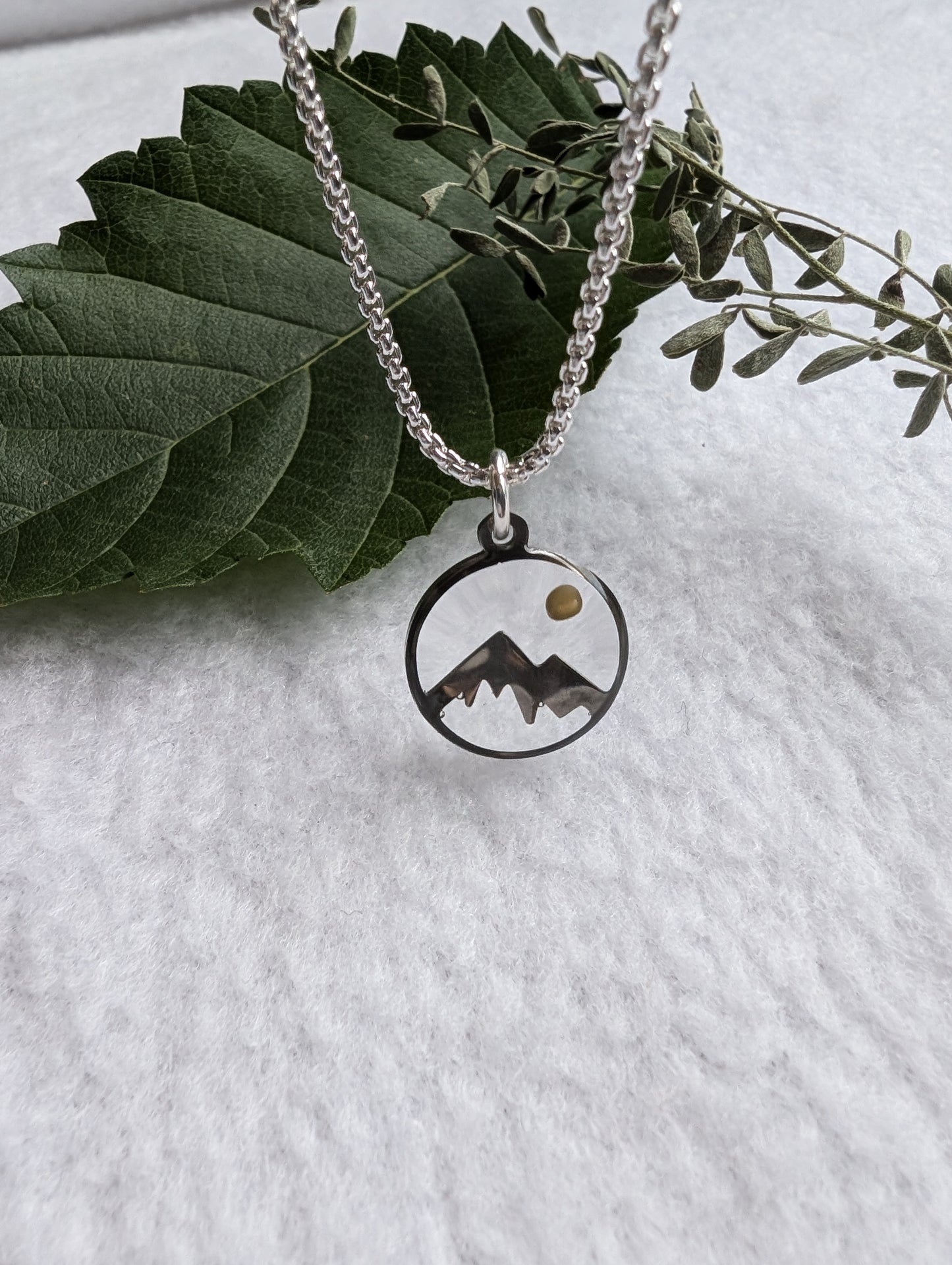 Silver mountain mustard seed pendant on a long silver box chain