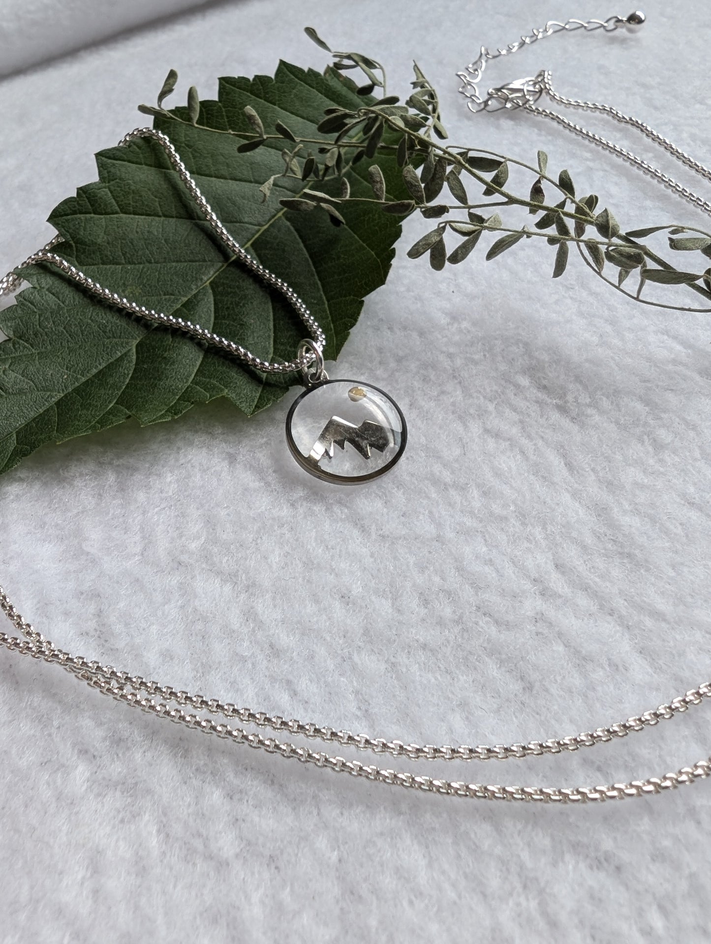 Silver mountain mustard seed pendant on a long silver box chain