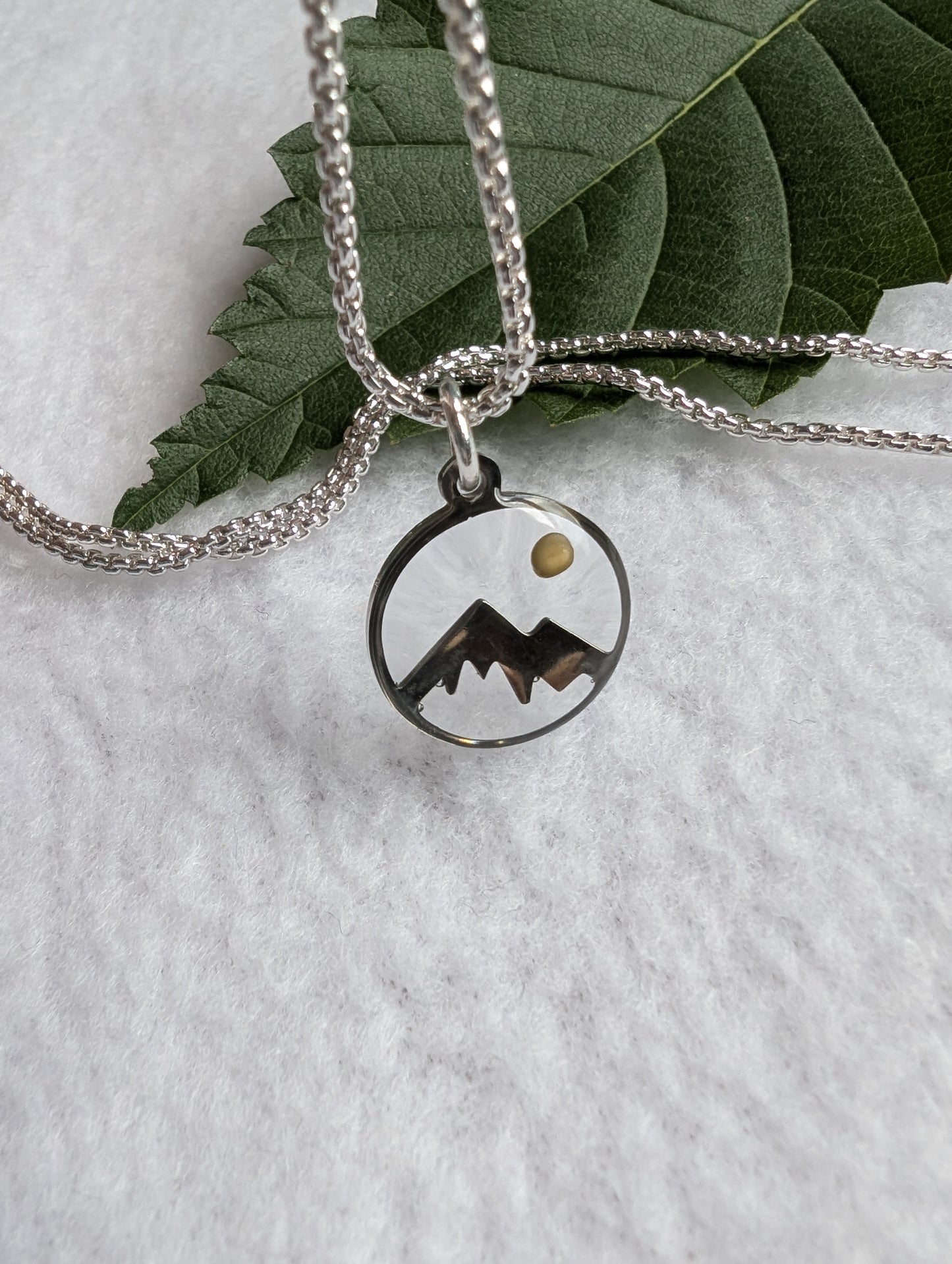 Silver mountain mustard seed pendant on a long silver box chain