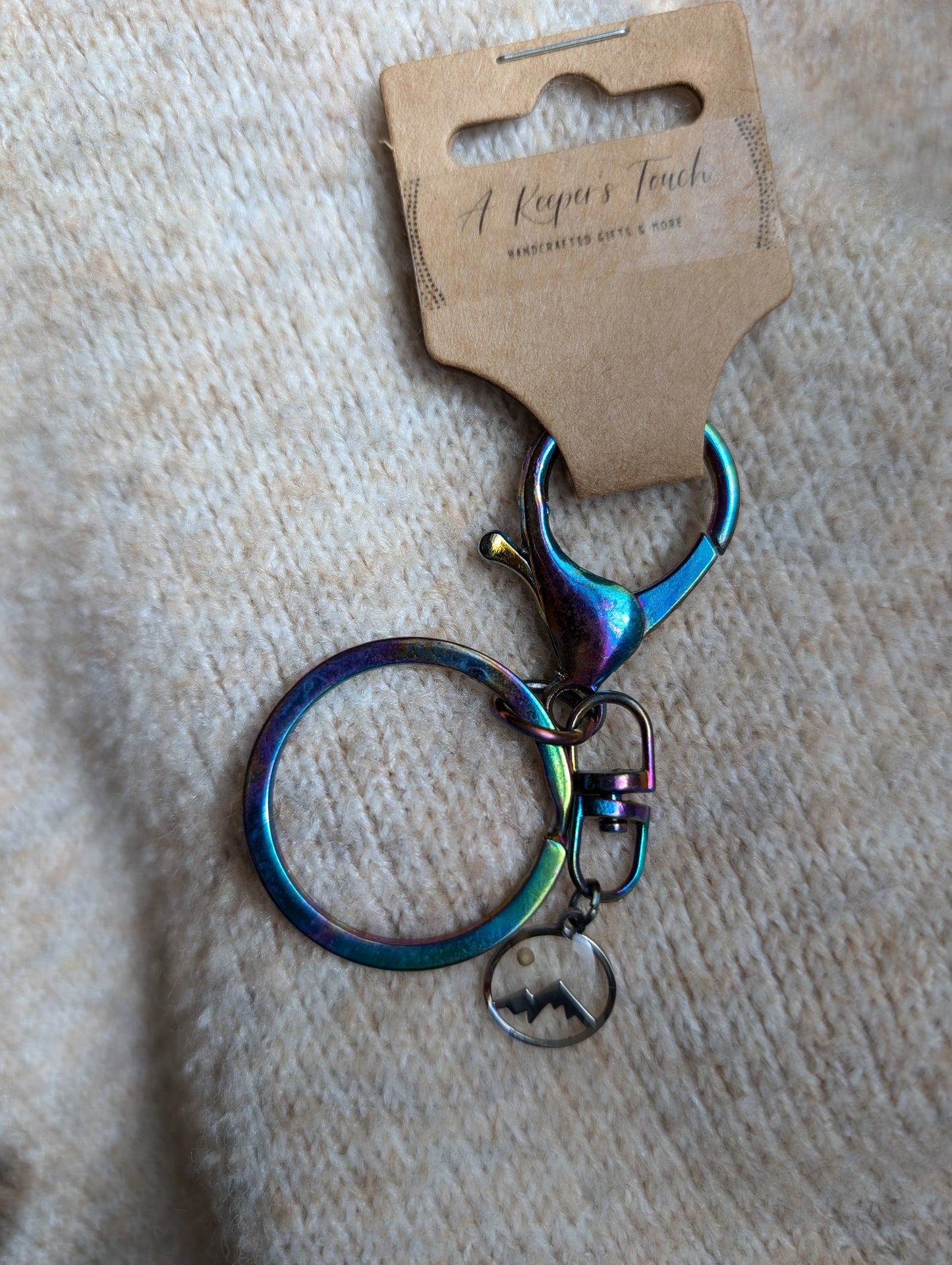 Iridescent metal keychain with mustard seed mountain charm