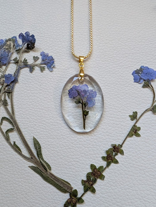 Clear gem; cluster forget-me-nots, long gold chain