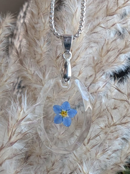 Clear gem; single forget-me-not, long silver chain